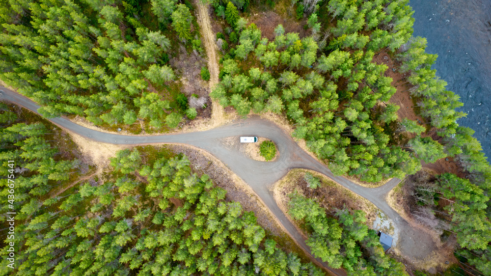 Aerial shot of the camper van in the middle of the forest