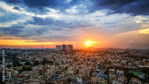 Sunset in Bangalore City India with blue, orange and yellow clouds photo
