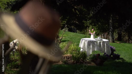 Table set with floral print tablecloth, with flowers on the table