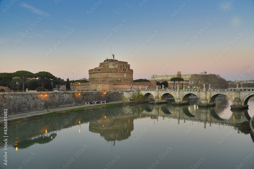 Castle Sant Angelo and Sant Angelo Bridge with it's Angel Statues at sunset in Rome, Italy