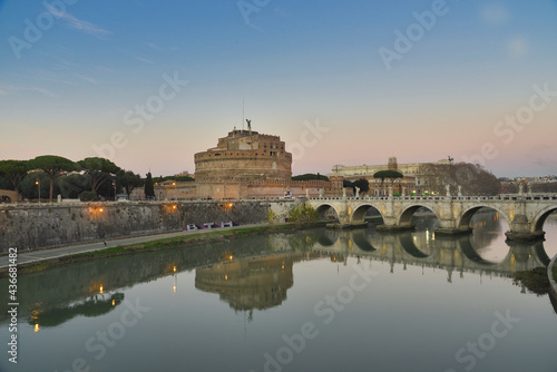 Castle Sant Angelo and Sant Angelo Bridge with it's Angel Statues at sunset in Rome, Italy