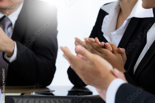 Close up young business people clapping hands. Employees congratulating with business achievement, great work results or job promotion, business people hands applauding at conference.