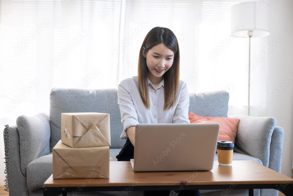 Asian woman working from home, SME business owner, Online marketing and delivery. Asian woman working from home, SME business owner, Online marketing and delivery.
