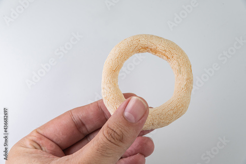 Brazilian food - biscoito de polvilho on the white background - man holding photo