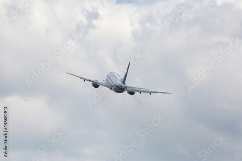 Passenger plane flying in cloudy sky