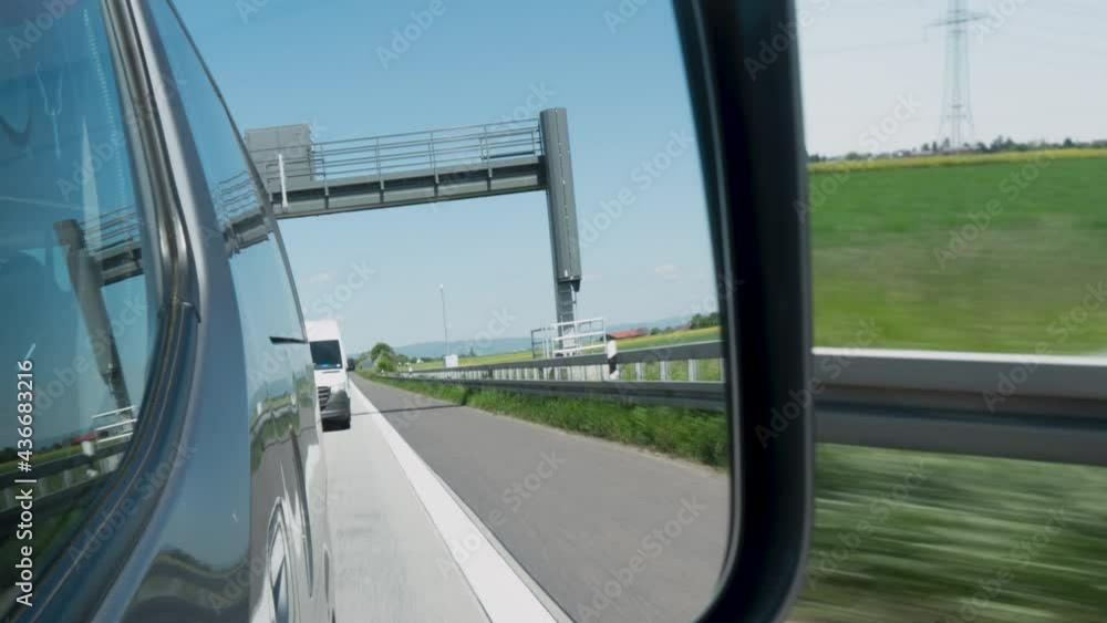 Driving on German highway on a sunny day - view through rear-view mirror, time lapse Driving on German highway on a sunny day - view through rear-view mirror, time lapse