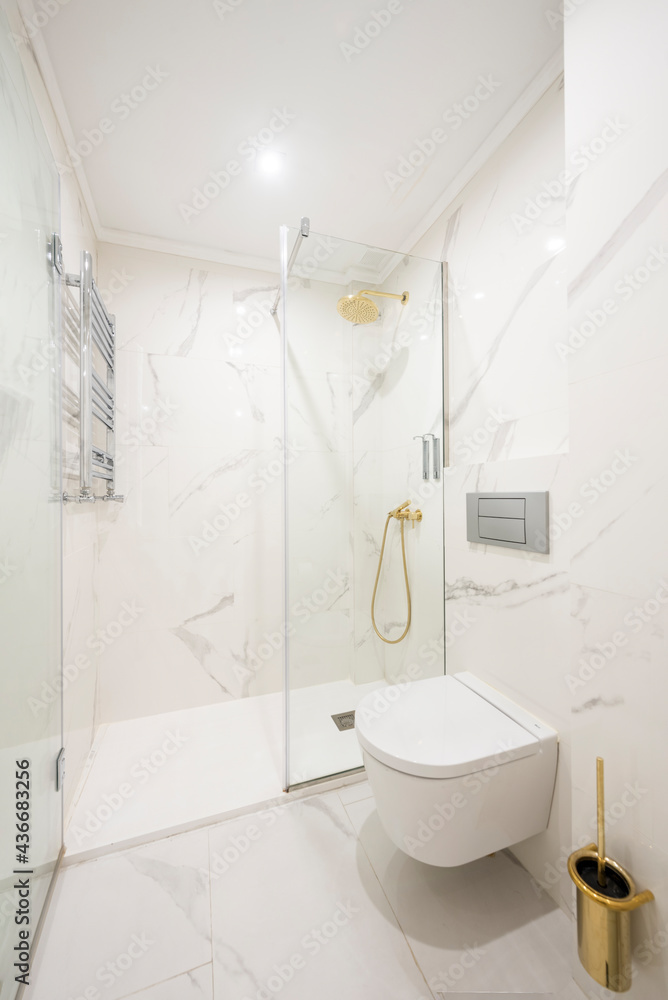 Shower with screen in white marble bathroom Shower with screen in white marble bathroom