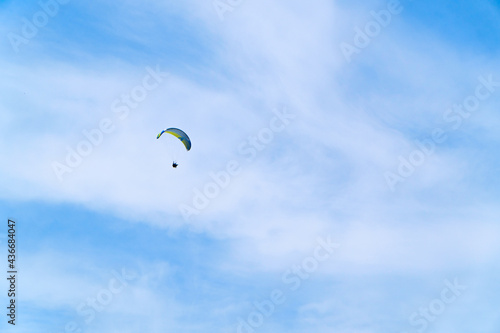 Paragliding in the blue sky. Man flying high