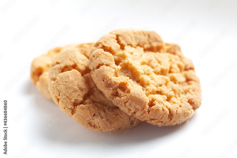 Close-up of delicious freshly baked simple cookies or biscuits. Isolated over studio white background Close-up of delicious freshly baked simple cookies or biscuits. Isolated over studio white background