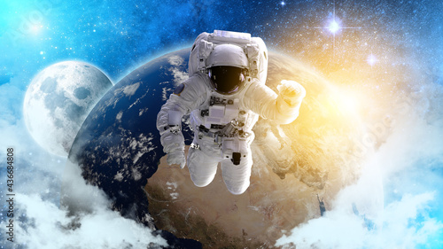 Fototapeta Naklejka Na Ścianę i Meble -  Astronaut in the outer space over the planet Earth. Abstract wallpaper. Spaceman. Elements of this image furnished by NASA.