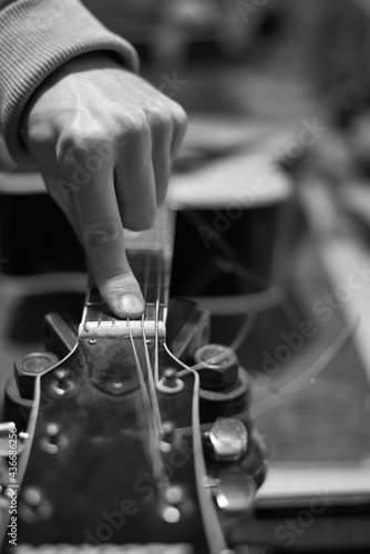 A service worker checks the sound of the guitar for further tuning.