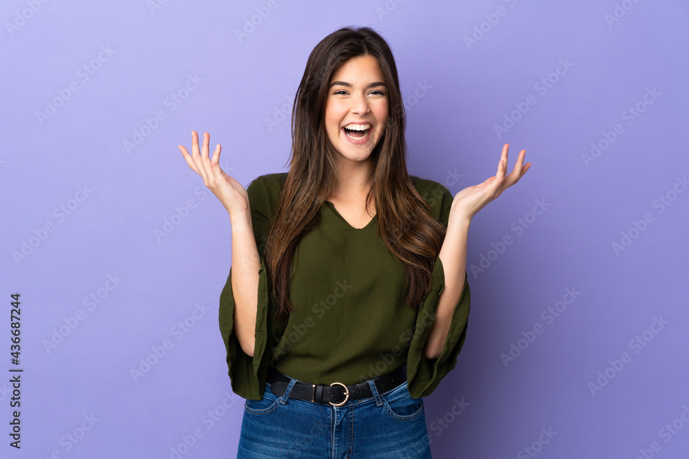 Teenager Brazilian girl over isolated purple background smiling a lot Teenager Brazilian girl over isolated purple background smiling a lot