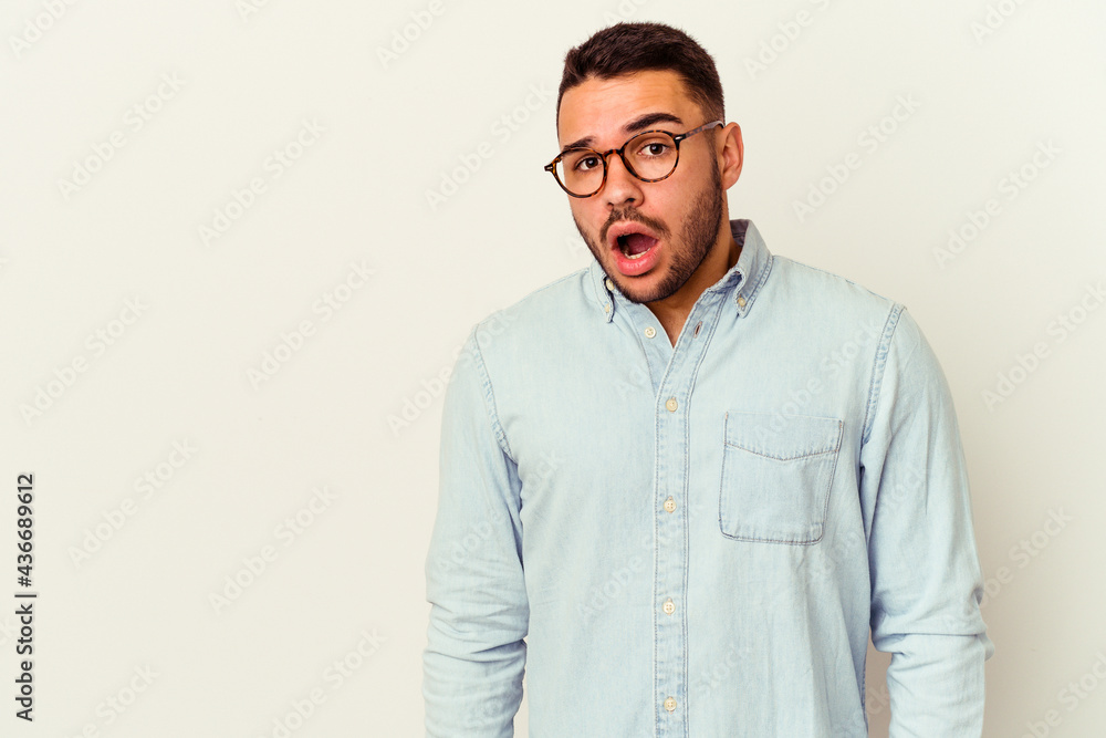 Fototapeta premium Young caucasian man isolated on white background being shocked because of something she has seen.