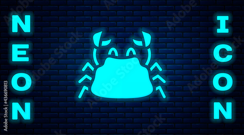 Glowing neon Crab icon isolated on brick wall background. Vector