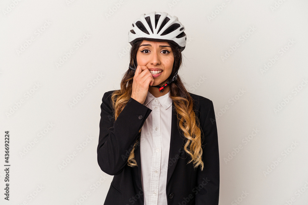 Young mexican woman riding a bicycle to work isolated on white background biting fingernails, nervous and very anxious. Young mexican woman riding a bicycle to work isolated on white background biting fingernails, nervous and very anxious.