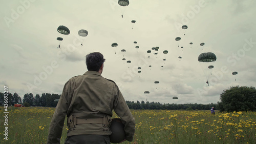 Photos Soldier looks at paratroopers in Normandy landings