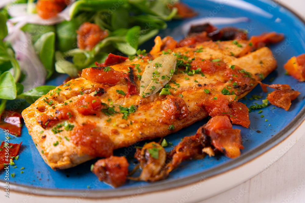Grilled palometa fish with chili and onion. Traditional tapa from southern Spain. Grilled palometa fish with chili and onion. Traditional tapa from southern Spain.