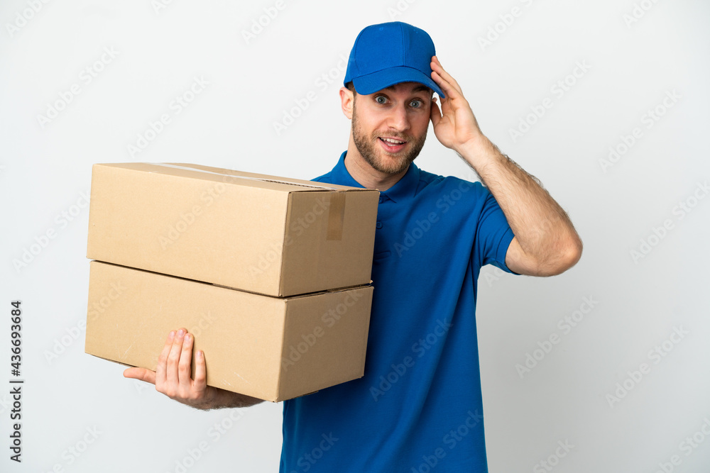 Delivery man over isolated white background with surprise expression Delivery man over isolated white background with surprise expression