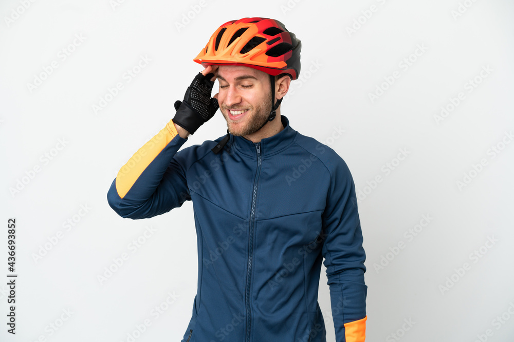 Fototapeta premium Young cyclist man isolated on white background smiling a lot
