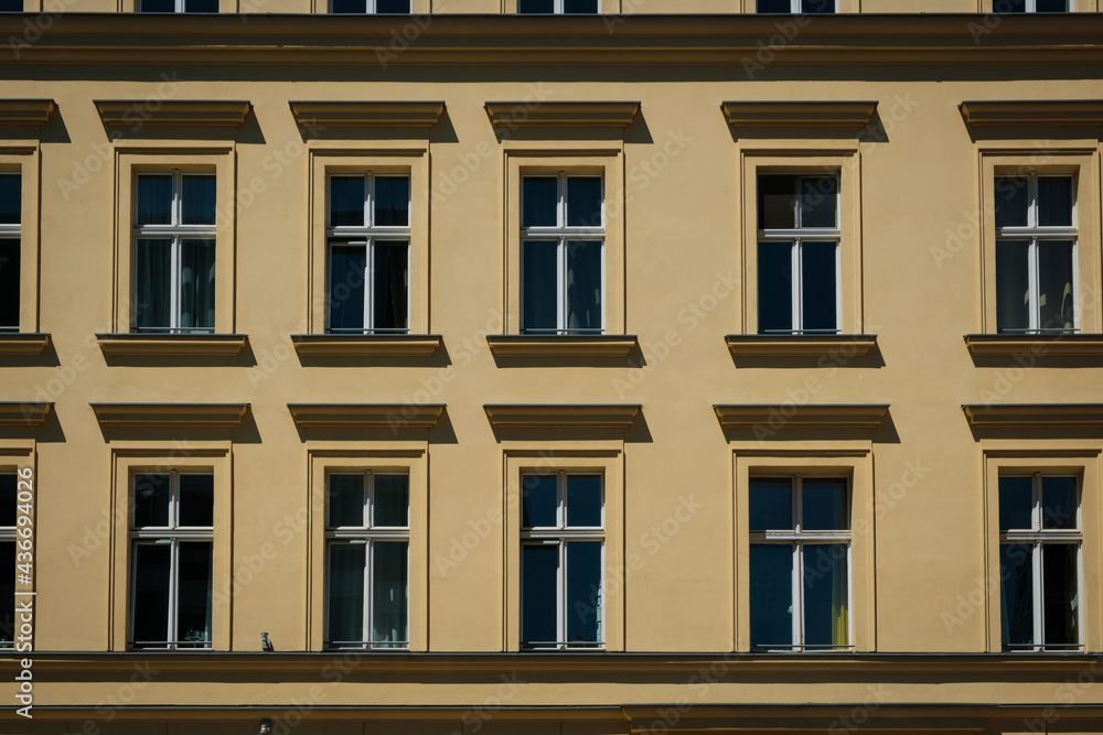 windows on old residential building facade, real estate exterior -