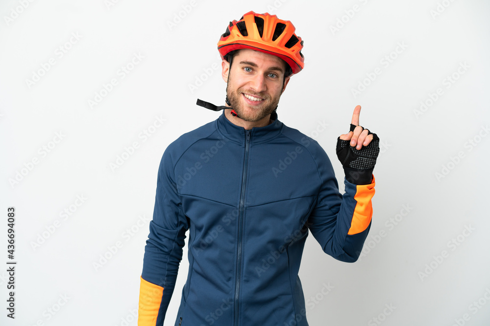 Young cyclist man isolated on white background showing and lifting a finger in sign of the best