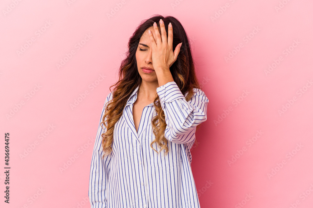 Young mexican woman isolated on pink background forgetting something, slapping forehead with palm and closing eyes. Young mexican woman isolated on pink background forgetting something, slapping forehead with palm and closing eyes.