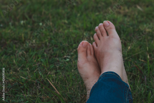 bare feet on grass, dramatic dark tone. © jajam_e