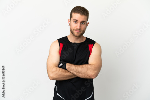 Handsome blonde man over isolated white background with arms crossed
