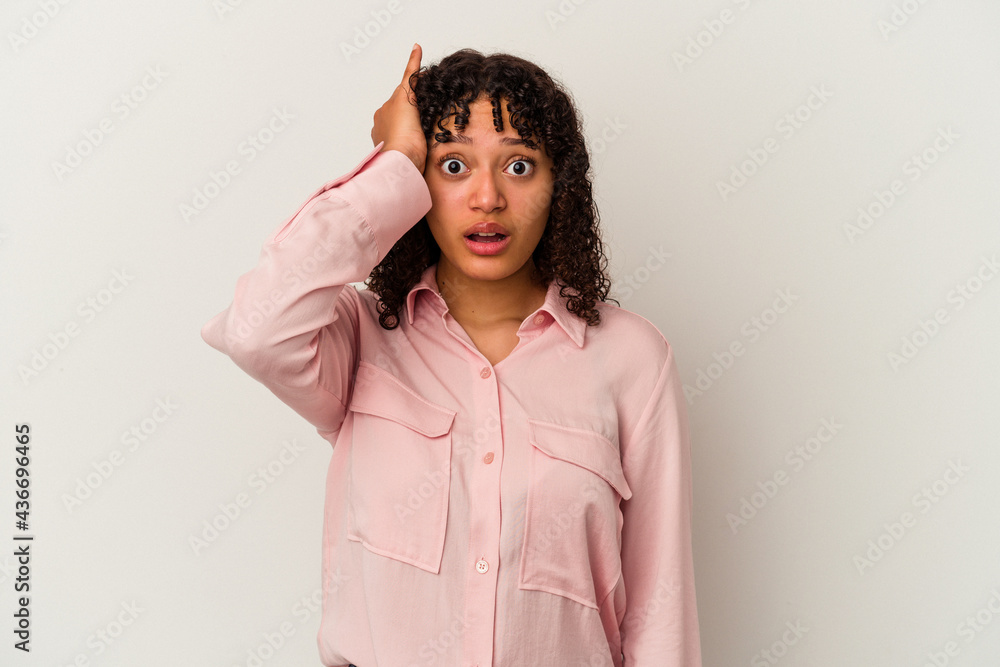Young mixed race woman isolated on white background being shocked, she has remembered important meeting. Young mixed race woman isolated on white background being shocked, she has remembered important meeting.