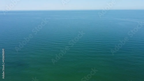 Aerial view of the azure blue seawater surface to the horizon for the natural background
