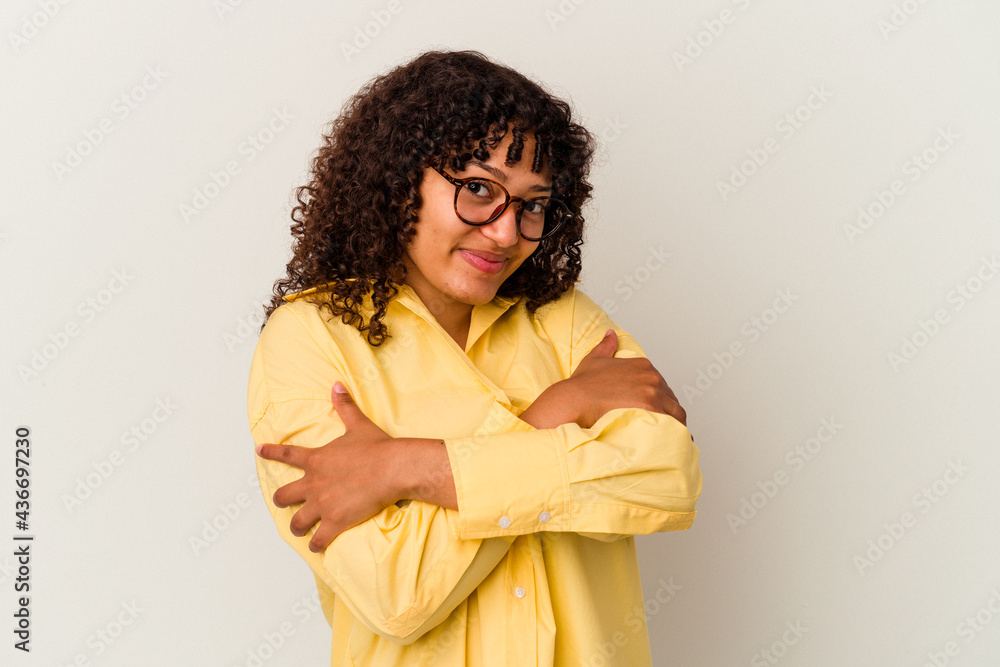 Young mixed race woman isolated on white background hugs, smiling carefree and happy. Young mixed race woman isolated on white background hugs, smiling carefree and happy.