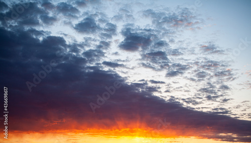 Colorful sunset or sunrise in the sky. The sky and clouds are painted in different delicate colors.