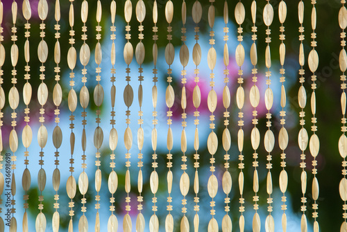 Bilde på lerret A beautiful beaded curtain hanging in a doorway with an out of focus background