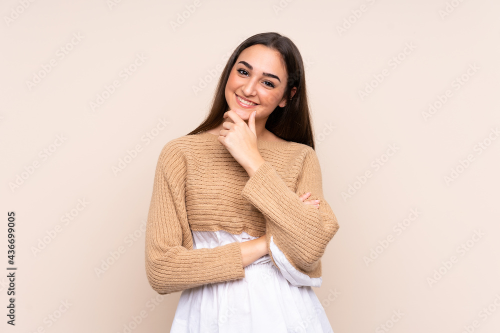 Young caucasian woman isolated on beige background looking to the side Young caucasian woman isolated on beige background looking to the side