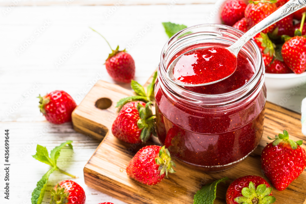 Strawberry jam in the glass jar with fresh berries. Close up. Strawberry jam in the glass jar with fresh berries. Close up.