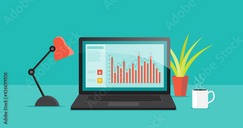 Business finance investment chart on laptop monitor with home office work space table concept