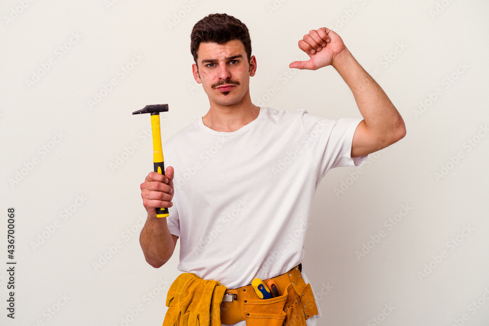 Young caucasian worker man with tools isolated on white background feels proud and self confident, example to follow. Young caucasian worker man with tools isolated on white background feels proud and self confident, example to follow.