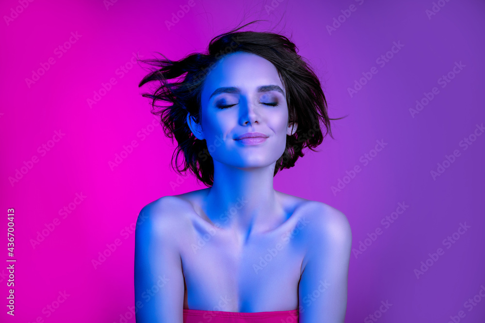 Portrait of attractive dreamy girl flawless shine skin air blowing hair isolated over bright lilac multicolor color background