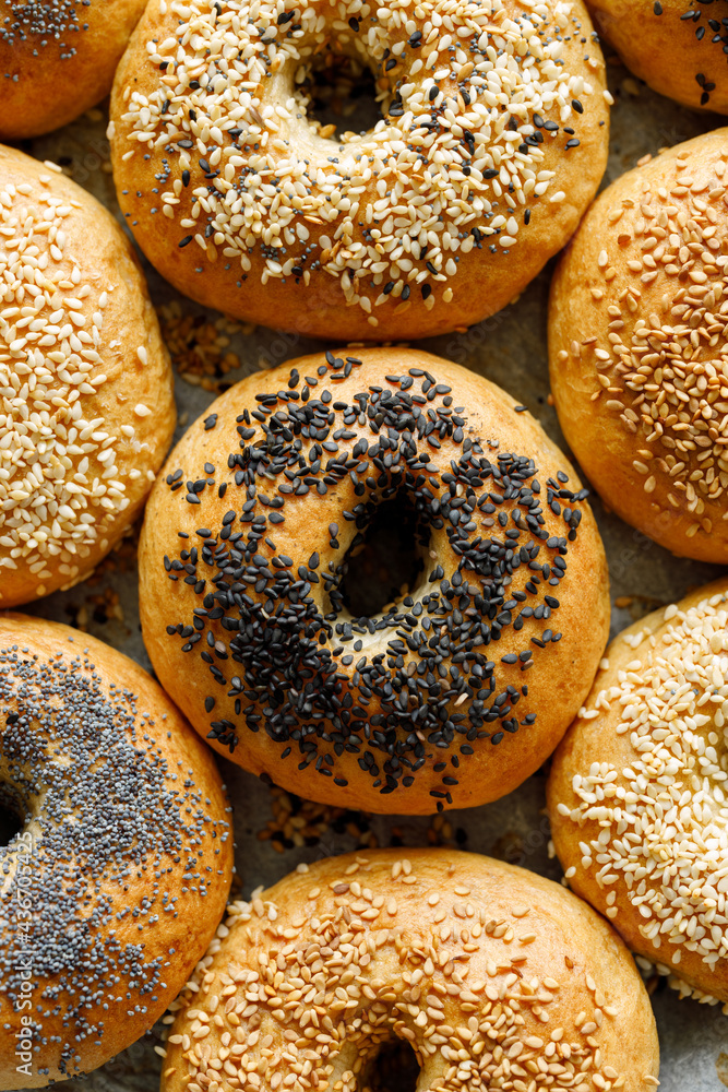 Raw bagels with the addition of various seeds prepared for baking, top view. Traditional bread Raw bagels with the addition of various seeds prepared for baking, top view. Traditional bread