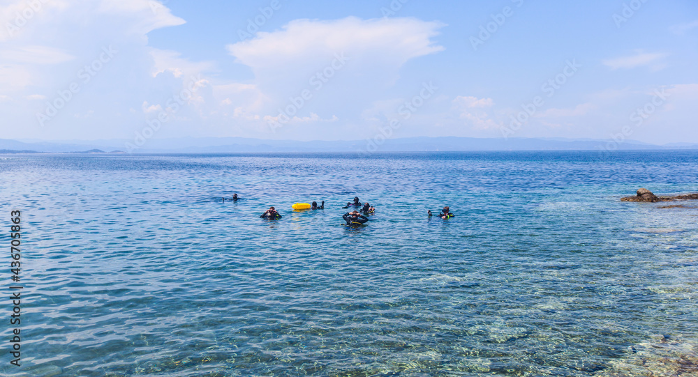 Group of scuba divers ready for diving