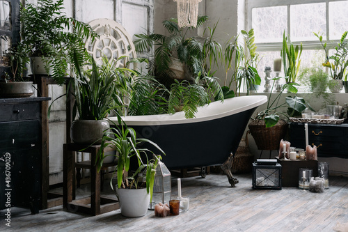 Bohemian bathroom with lots of potted greenery photo