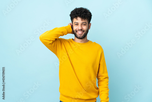 Young Moroccan man isolated on blue background laughing © luismolinero