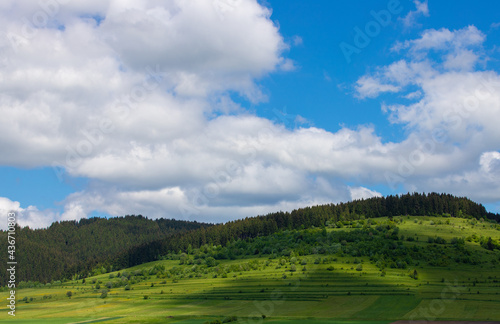 summer landscape with shadows of clouds on the hills