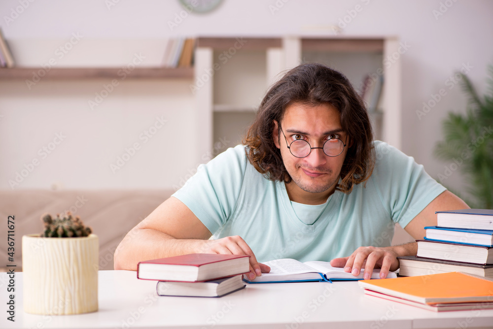 Young male student preparing for exams at home Young male student preparing for exams at home