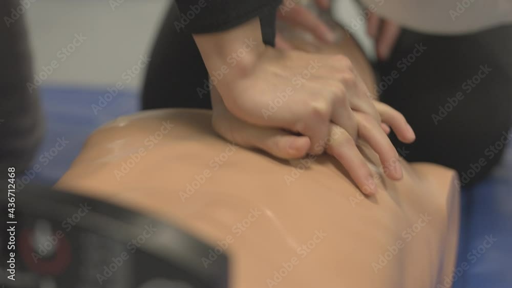 A Person Doing Chest Compressions On A Dummy A Person Doing Chest Compressions On A Dummy