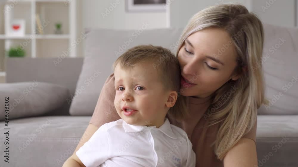 Happy young mum hugging kid son sooting sleepy kid at home. Cute toddler boy and caring mother bonding, cuddling together. Adorable small child boy and mom enjoying moments of love and affection. Happy young mum hugging kid son sooting sleepy kid at home. Cute toddler boy and caring mother bonding, cuddling together. Adorable small child boy and mom enjoying moments of love and affection.