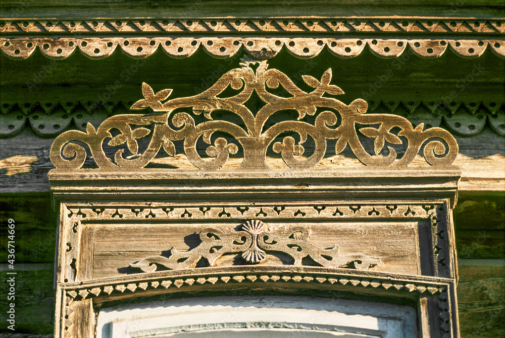 old window of a Russian house of the past and before last centuries with elements of decoration (Part of the window, close-up)