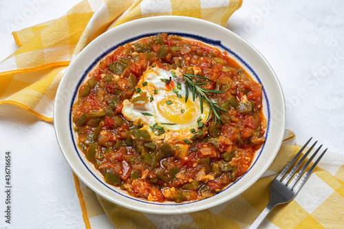 Vegetable dish pisto manchego made of tomatoes, zucchini, peppers, onions with fried egg photo