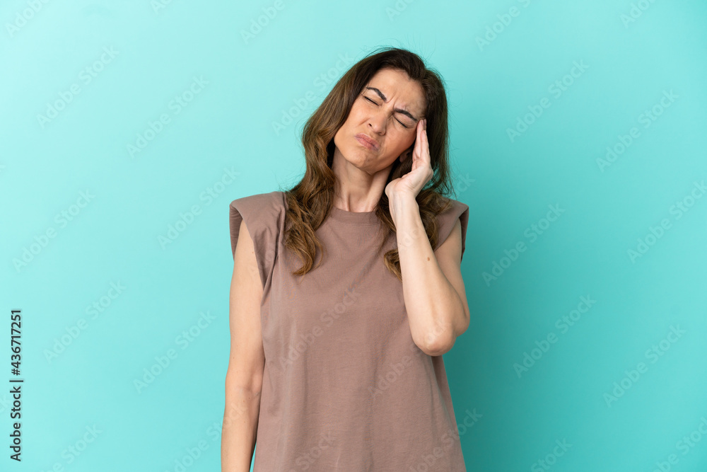 Middle aged caucasian woman isolated on blue background with headache Middle aged caucasian woman isolated on blue background with headache