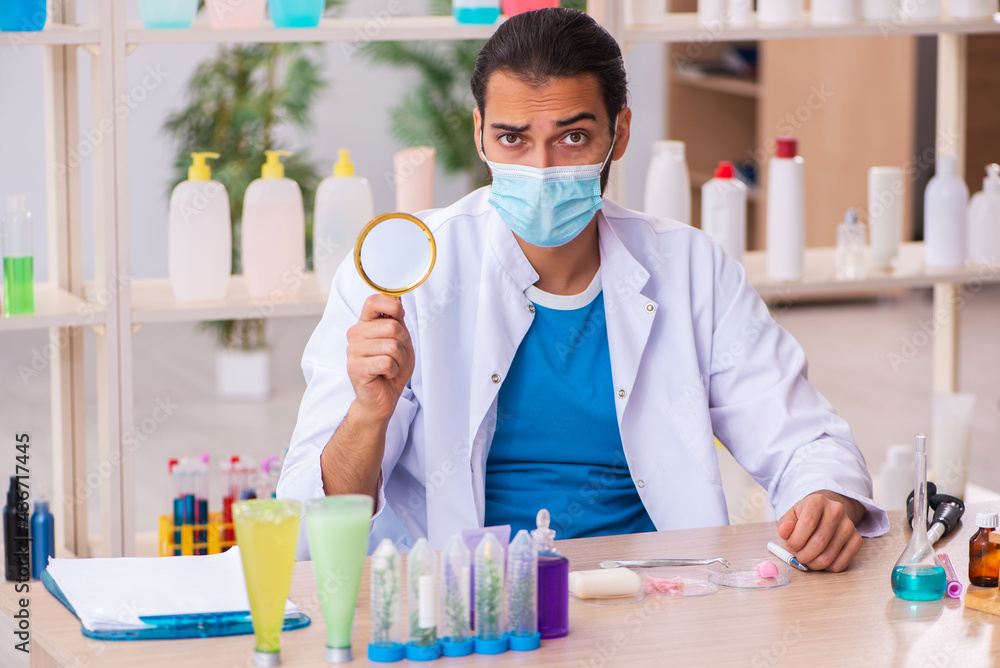 Young male chemist testing soap in the lab Young male chemist testing soap in the lab